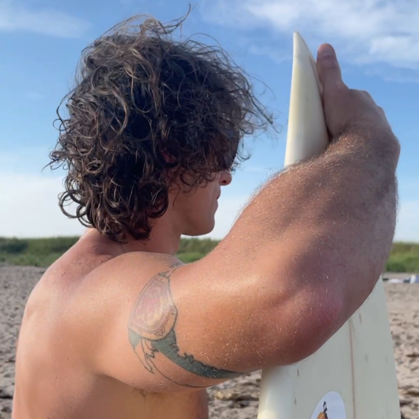 Person with curly hair men's hair salty hair beach hair.