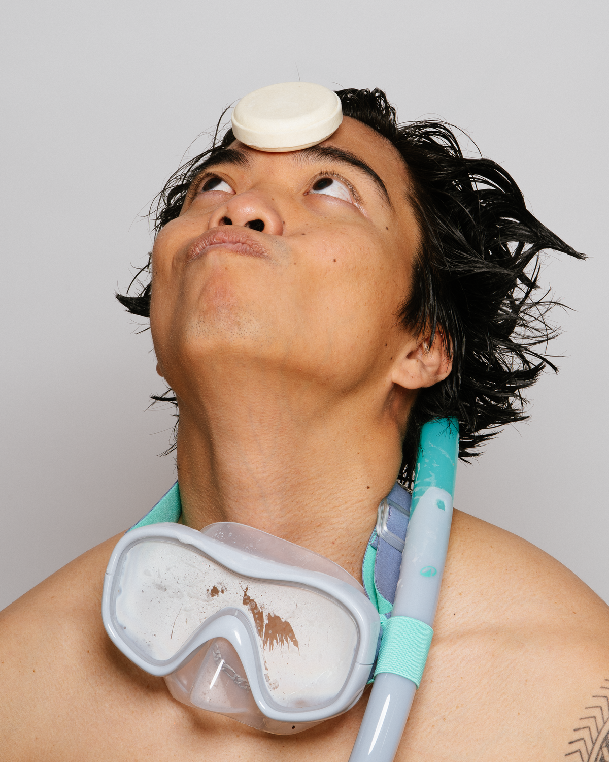 Salty Hair Surf Shampoo Balanced on Forehead in Playful Shot